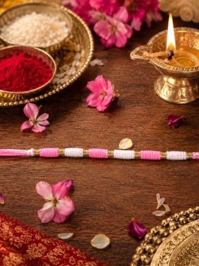 Pink & White Thread Rakhi � Elegant Traditional Beaded Design